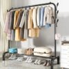 Single pole clothing rack with lower storage shelf for boxes and shoes